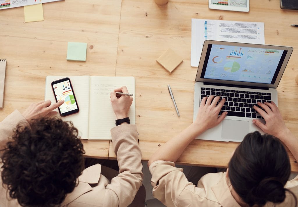 Employees using an ERP system with in-app guidance and digital adoption tools to improve software adoption and productivity.