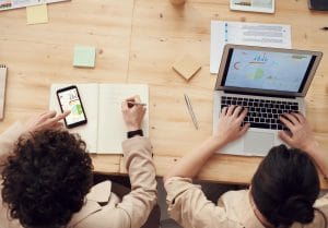 Employees using an ERP system with in-app guidance and digital adoption tools to improve software adoption and productivity.